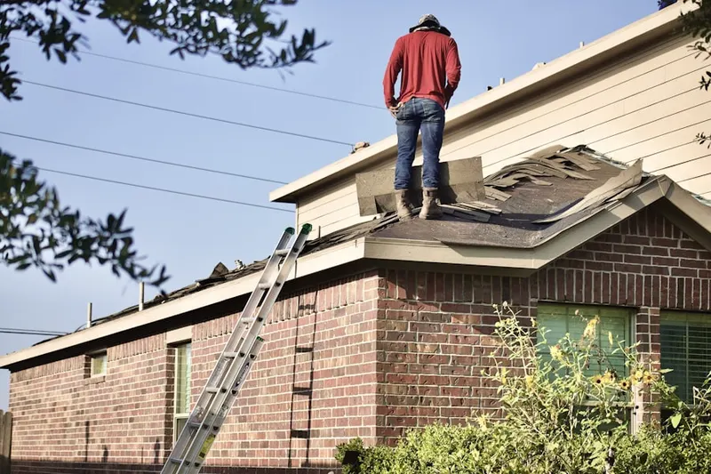 Professional roofer working on a residential roof in Phoebe Berks Village